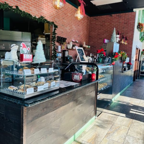 Interior of Best Artisan Empanadas, featuring display cases filled with empanadas and festive holiday decorations.